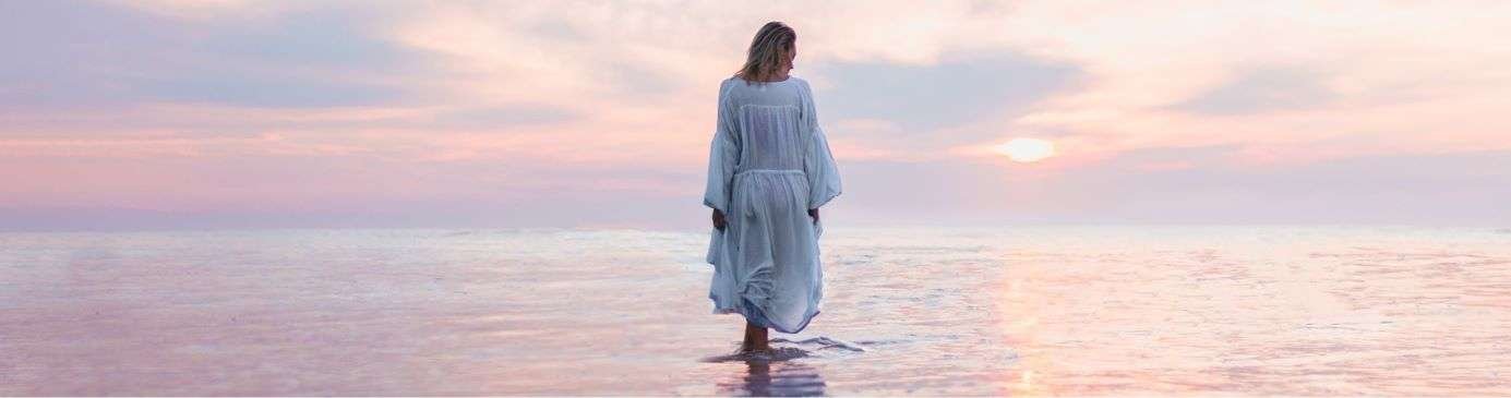 Hypnosis for spiritual support - woman walking in the sea